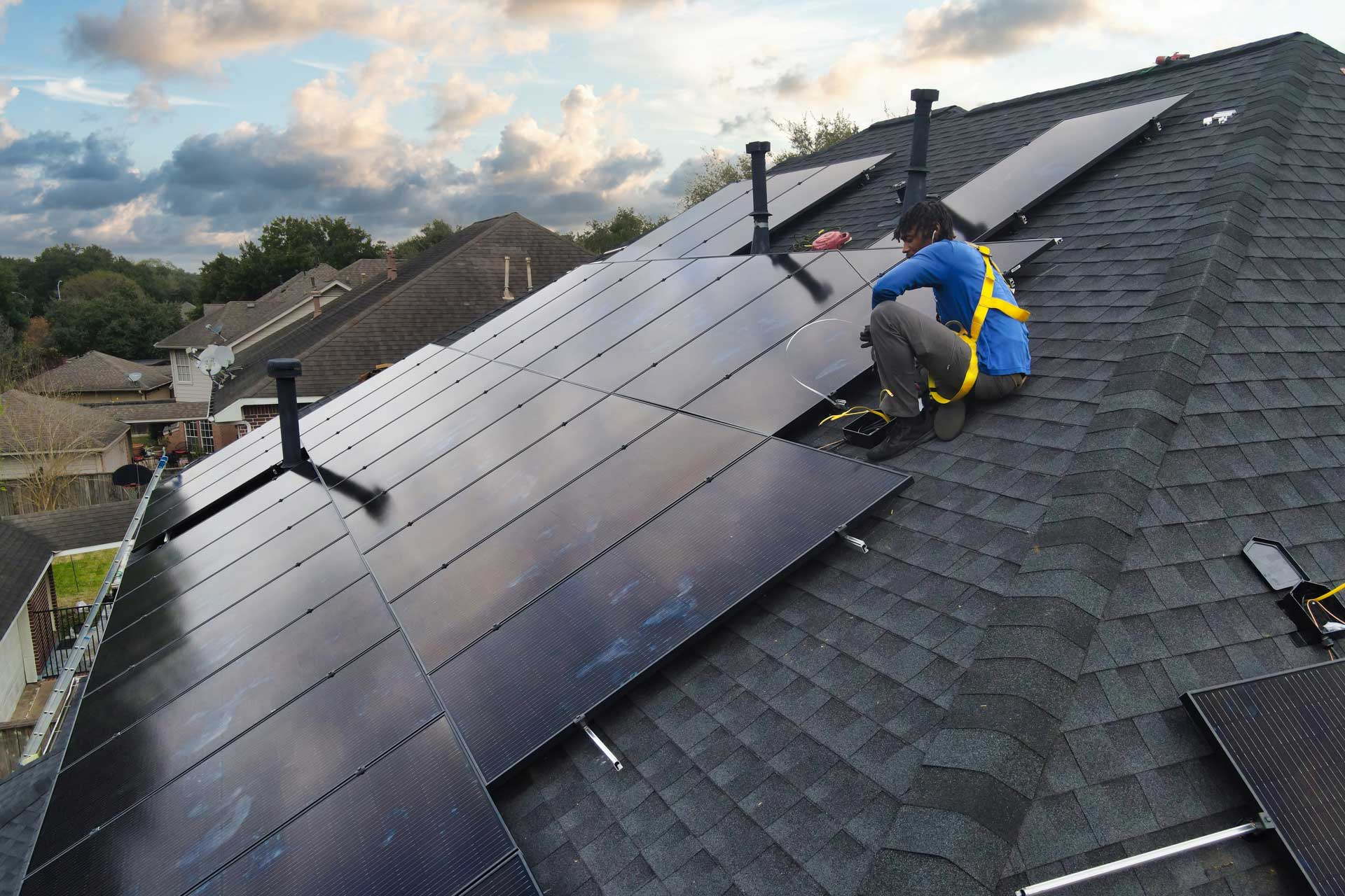 One of our Solstice Solar installers in the midst of mounting solar panels on a residential rooftop in Houston, Texas.