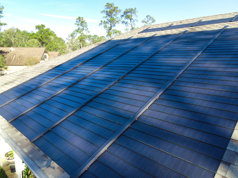 Close-up of black solar panels showing photovoltaic cells designed to capture sunlight.