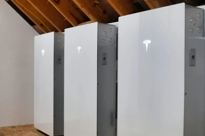 Three Tesla Powerwall 3 units installed for home energy storage.