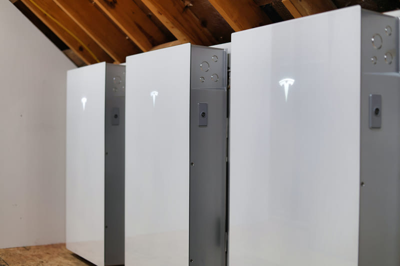 Three Tesla Powerwall 3 units installed for home energy storage.